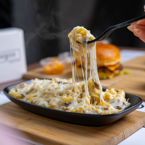 Shrimp Creamy Pasta - Spiral pasta, shrimp, mushroom, garlic, mozzarella cheese, Parmesan cheese, spices, and white sauce.