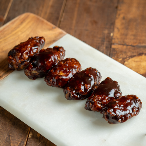 BBQ Chicken Wings - Fried breaded chicken wings mixed with bbq sauce.