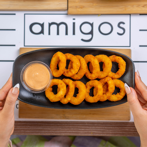 Onion Rings - Eight Pieces of Breaded onion rings served with smoky sauce.