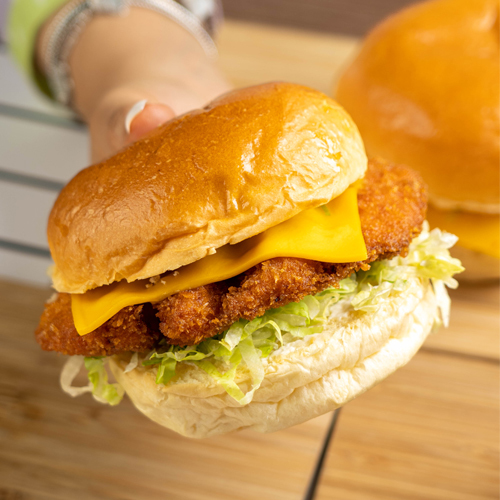 Crispy Chicken Sandwich - Fresh potato bun, fried chicken, lettuce, tomatoes, cheddar cheese and mayonnaise.