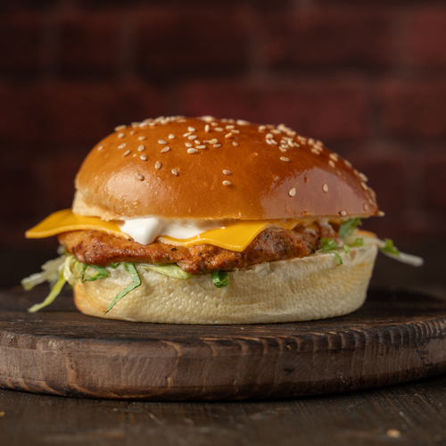 Grilled Chicken Sandwich - Fresh potato bun, mayonnaise, tomato, lettuce, cheddar cheese.