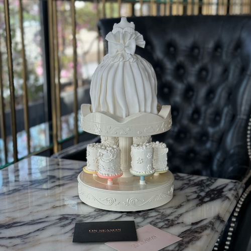 Luxury bride - cake A - Rotating music cake stand with a Bride cake on top filled with layers of brownie, red velvet, and rich cheese cream, 6 mini cakes below, and a complimentary candle.