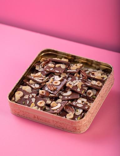 Slab Nuts - Thin pieces of milk chocolate filled with caramel and praline, layered with a rich layer of nuts. Box of 30 pieces.