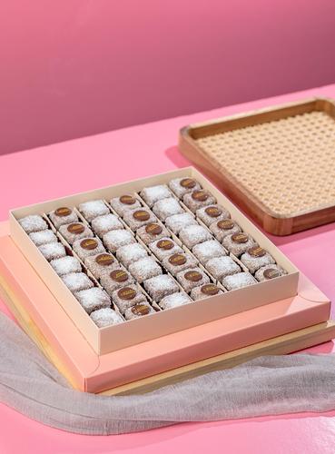 Pinacolada Deluxe - Thin and fluffy slices of pineapple cake Drenched in Swiss cocoa sauce with soft and rich grains of caramelized coconut flakes and original Box of 42 pieces