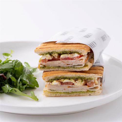 Turkey and Cheese - White ciabatta with smoked turkey breast, fresh mozzarella, basil pesto, sliced tomato and balsamic glace served with mix salad.