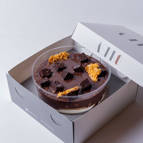 Layers Of Heaven - Chocolate sponge cake served with peanut butter and cream, on top of digestive chunks and peanut butter Reese's.