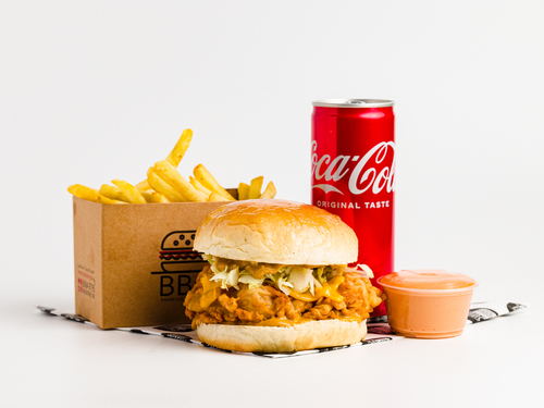 Crispy Chicken Meal - Crispy chicken fillet in brioche bun, lettuce, cheese, special sauce, cola, and French fries.