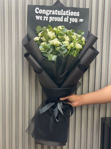 GRADUATION BOUQUET - BLACK WRAPPING WITH BABY ROSE AND EUCALYPTUS STICKERS WRITING WITH TOOR please note flowers are seasonal and we change the flower depending on the availability of the stocks.