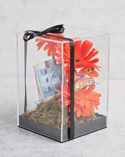 ACRYLIC MONEY BOX WITH FLOWERS - FLOWERS, EMPTY MONEY BOX Please note flowers are seasonal and we change the flower depending on the availability of the stocks.