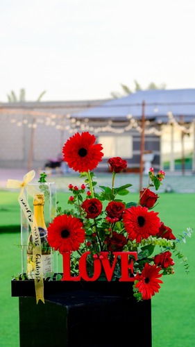 NEW YEAR 2025 - An acrylic tray containing flowers and a sparkling drink in an acrylic box and a wooden base with the word love and the phrase New Year.