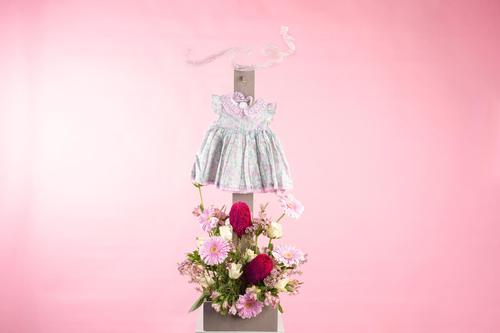 NEW DESIGN 006 - The Wood stand contains flowers and baby girl dress.