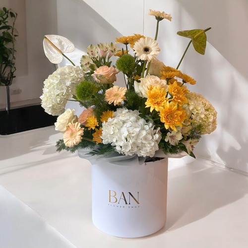 Sunny Serenity Bouquet - A delightful arrangement of white and yellow flowers in a chic white box. Perfect for any occasion, this cheerful bouquet brings warmth and elegance, making it an ideal gift to brighten someone’s day!