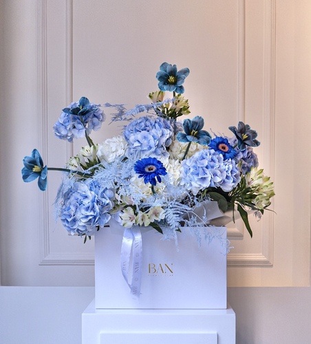 Baby Blue Joy - A cheerful mix of white and colored hydrangeas, vibrant Alstroemeria, painted tulips and gerberas, and dyed asparagus for a joyful floral display.