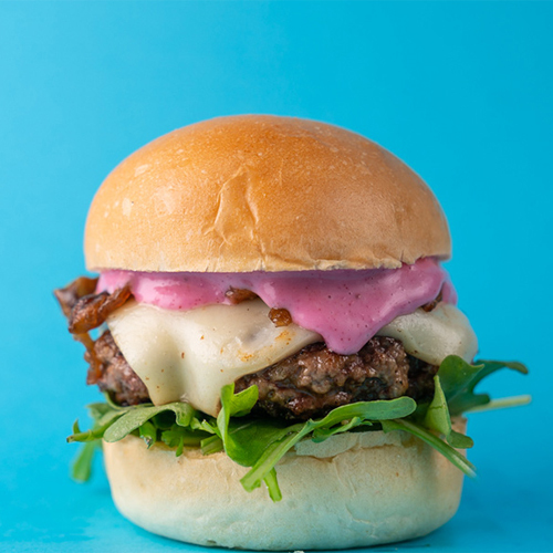 Pink Panther Slider - Beef patty with white cheddar cheese, italian rocca, caramelized onion and beetroot sauce.