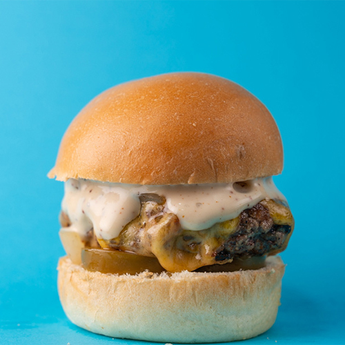 Lets Slider - West Coast Slider - Marinated beef patty with yellow cheese topped with grilled diced onion with chipotle and ranch sauce.