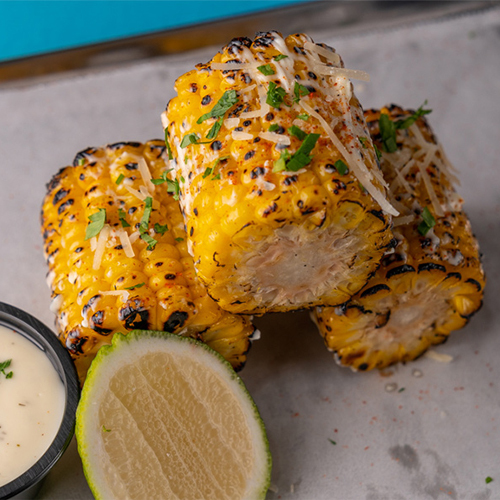 Mexican Corn - Roasted corn with mayonnaise and sour cream sauce.