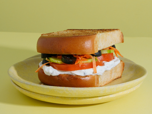 LABNEH - Brioche toast, labneh and zaatar mix with shredded carrots, cucumber and tomatoes