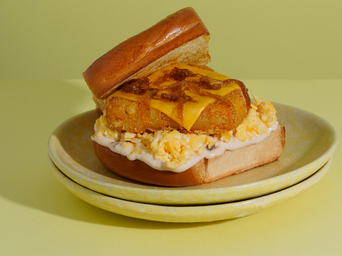 CHEESY HASHBROWN AND EGG - Brioche toast with scrambled eggs, cheese, hash brown, caramelized onion and our special sauce