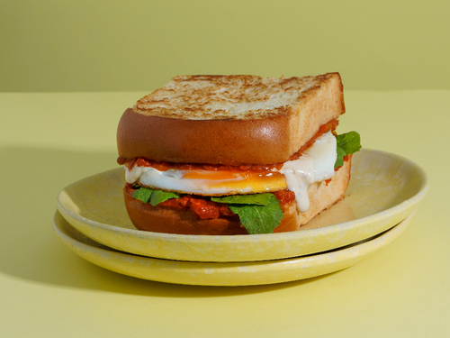 SHAKSHUKA - Brioche toast with shakshuka eggs and rocca.