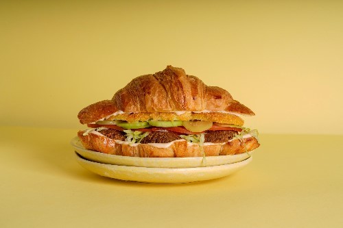 SPICY FALAFEL - CROISSANT, falafel, pickles, tomatoes, hash brown, spicy tahini.