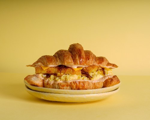 CHEESY HASHBROWN AND EGG - CROISSANTt with scrambled eggs, cheese, hash brown, caramelized onion and our special sauce