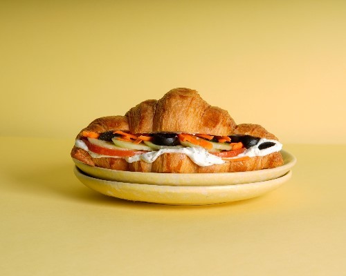 SPICY LABNEH - CROISSANT, labneh and zaatar mix with shredded carrots, cucumber and tomatoes