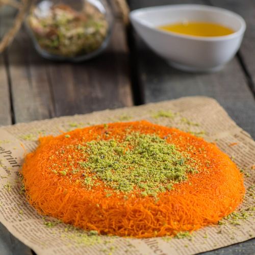 Orange - Coarse Kunafa stuffed with Nabulsi cheese, fresh cream, or both, in halves