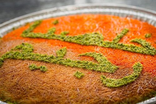 Malakiyah Half-half - Half orange and half blonde kunafa with a mixture of nuts filling