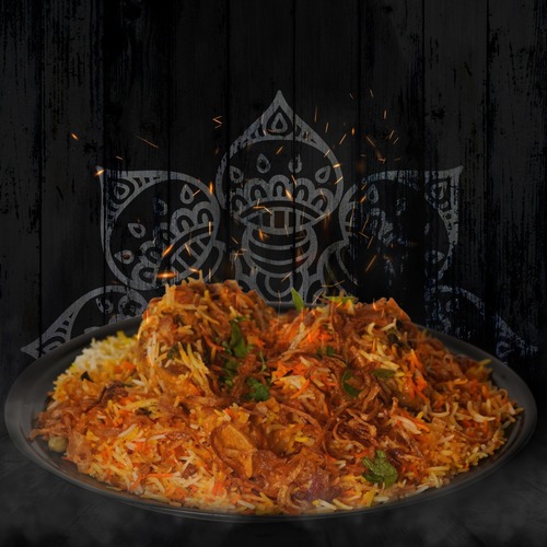 Chicken Biryani - Half a bone-in chicken cut into pieces and prepared with delicious biryani sauce. This dish is served with maabouj, arugula, onions and lemon.