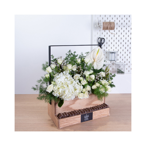 La Vie - This wooden basket contains white hydrengia, white baby roses, white anthurium, asparagus and safari with Belgian chocolates. 
Height: 45cm  Width: 40cm  Sell by: Quantity