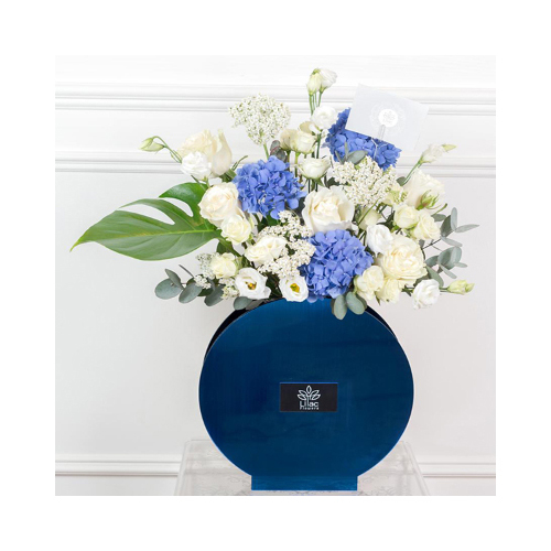 Blue Sky - This acrylic blue vase contains white roses, baby roses and hydrangea flowers with green leaves. 
Height: 65cm  Width: 30cm  Sell by: Quantity