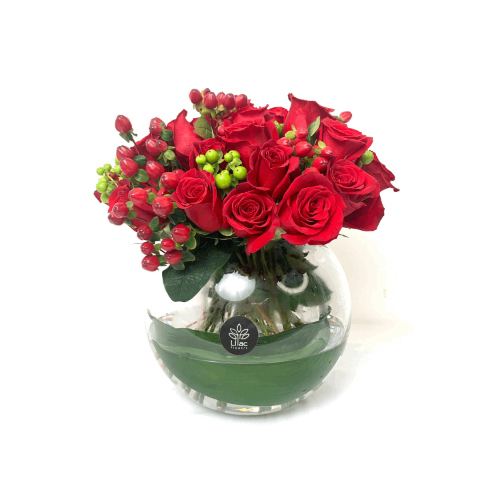 Romantic Red - A round glass vase full of red roses and others with green leaves.
 Height: 35cm  Width: 30cm  Sell by: Quantity