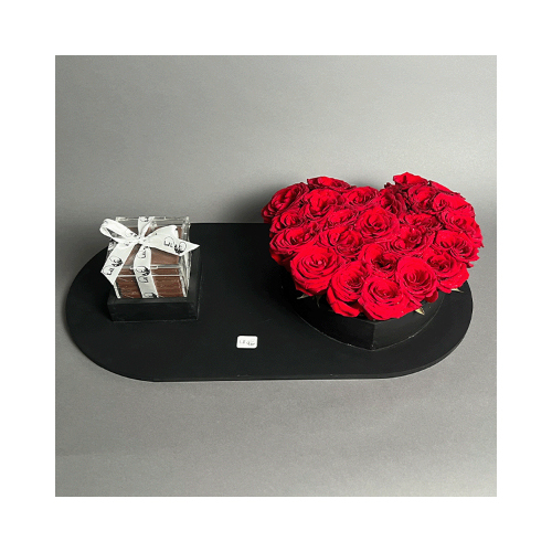 Pretty In Red - A wooden black tray with red roses in s heart shape and Belgian chocolates. 
Height: 10cm  Width: 53cm  Sell by: Quantity