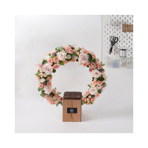 Princess S - This ring stand filled with shades of pink roses and baby roses with Belgian chocolates. 
Height: 65cm  Width: 55cm  Sell by: Quantity