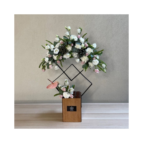 Double Squared 1 - This double squared stand contains peach anthurium and baby roses flowers with Belgian chocolates.
 Height: 80cm  Width: 35cm  Sell by: Quantity