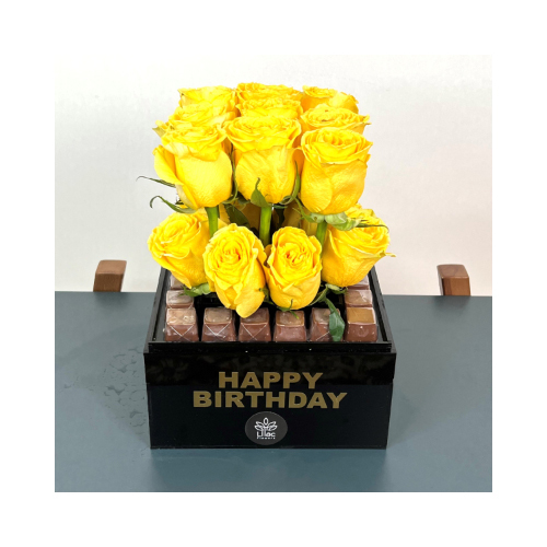 Birthday Dreams - Acrylic black box with yellow roses surrounded by Belgian chocolates covered by a transparent acrylic cover with happy birthday sticker.
 Height: 35cm  Width: 20cm  Sell by: Quantity