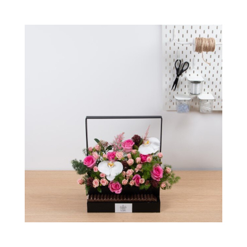 French Pink - This black wooden basket contains orchid petals, astilbe and mix of pink roses with Belgian chocolates.
 Height: 45cm  Width: 40cm  Sell by: Quantity