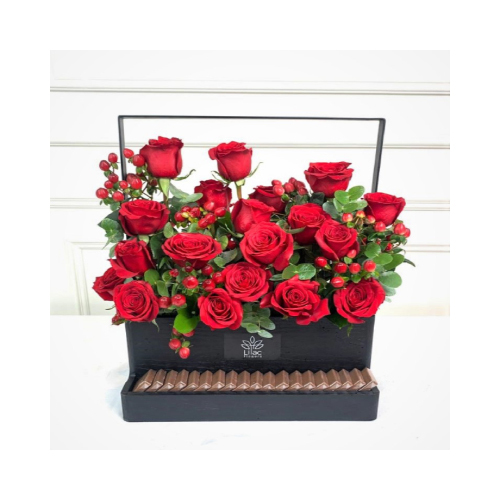 Love Basket - A black wooden basket contains roses and hypericum flowers with green leaves and Belgian chocolates.
 Height: 35cm  Width: 40cm  Sell by: Quantity