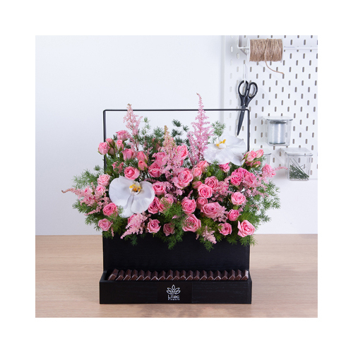 Absolutely Roses - This black wooden basket contains cat flower petals, astilbe pink baby rose and asparagus with Belgian chocolates.
 Height: 45cm  Width: 40cm  Sell by: Quantity