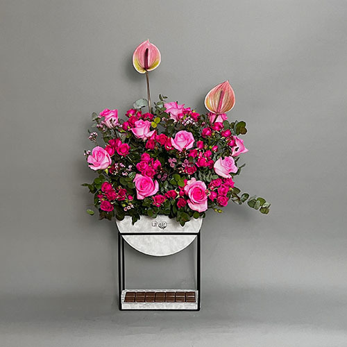 Tropical Summer - High stand vase with pink rose, pink anthurium, fuchsia baby rose and purple wax with Belgian chocolate  
 Height 100  Width 50