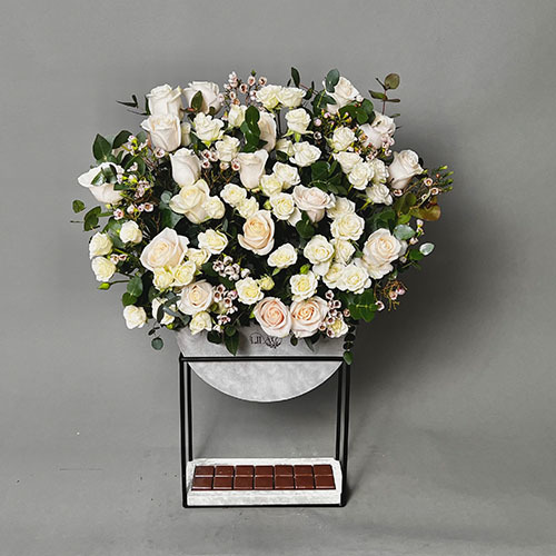 Stylish spring - Hight stand vase with white rose, baby rose and wax with Belgian chocolate  
 Height 100  Width 50