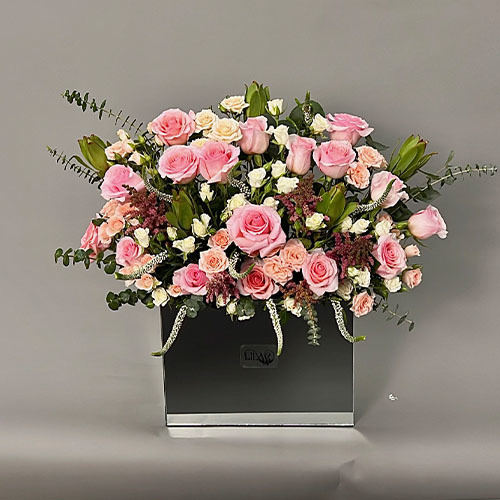 Lilac Flowers  - Pretty in pink - Mirror vase with pink rose, pink baby rose, white baby rose, peach baby rose and Veronica  
 Height 65 Width 75