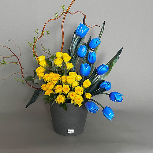 Blue Tulip - Grey vase with blue tulips, yellow baby rose and salix 
 Height 65 Width 40