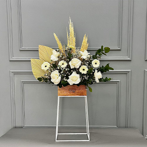 Cool white - wooden hight vase with white rose, white wax, and white garebera  
 Height 110  width 75