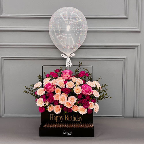 Birthday basket - Black wooden basket with pink rose, fuchsia baby rose, pink rose، balloon and Belgian chocolate  Height 85  Width 54