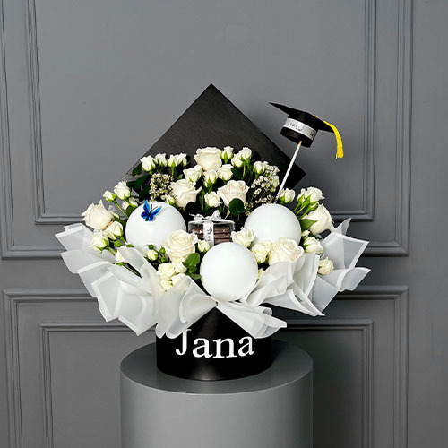 Graduation cap - Personalized graduation Cap contain white rose, white baby rose, white wax، balloons and Belgian chocolate with mini graduation cap topper.  Size: Height 60  Width 60  Optional: writing on the item maximum 10 charcters