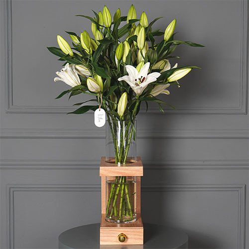 Casablanca 1 - This wooden stand contains white Casablanca flowers with Belgian chocolate. Height 91  width 52