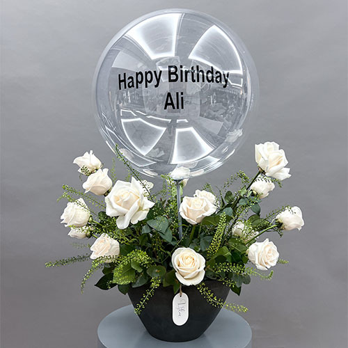 Mile - Dark grey vase contain white rose and a personalized transparent balloon. personalized writing on the item maximum 13 characters Height 72  Width 58