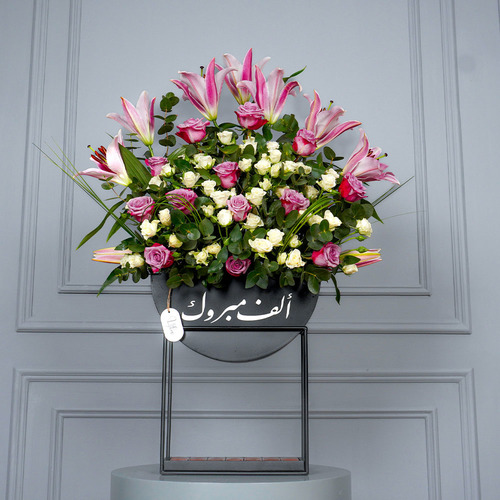 Joa - wooden stand contain pink lilies, purple rose, white baby rose and Belgian chocolate. Height 95  Width 63