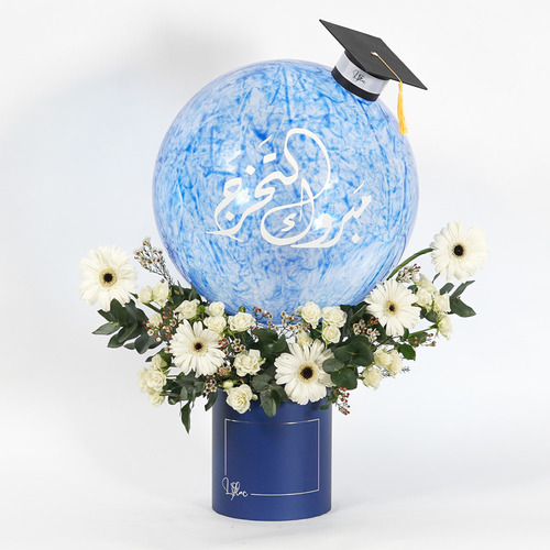 Abadi - Blue box contains large size balloon, mini graduation cap, white gerbera, white baby rose and white wax You can add Belgian chocolate with the bouquet  Height 76 Width 68